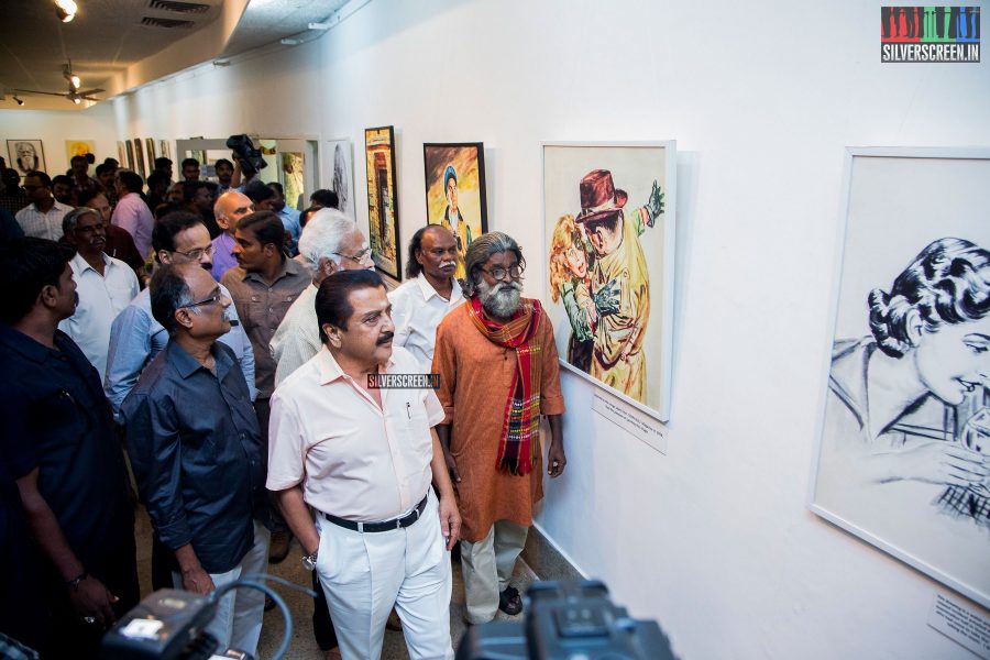 Sivakumar looks on as guests view the paintings on display