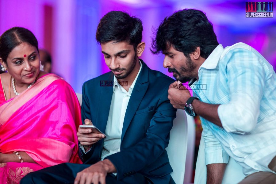 Anirudh and Sivakarthikeyan huddled over another iPhone